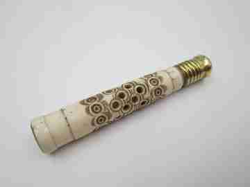 Pincushion. Carved openwork bone and golden metal. Circular pattern
