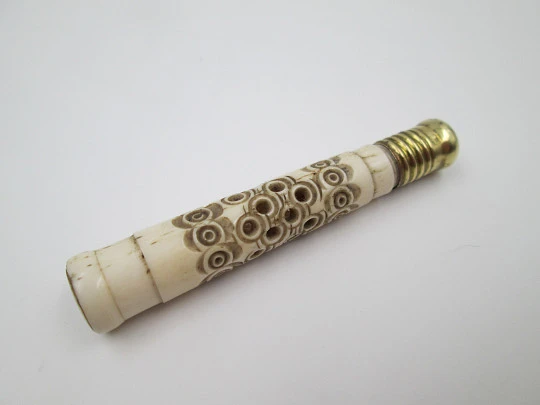 Pincushion. Carved openwork bone and golden metal. Circular pattern