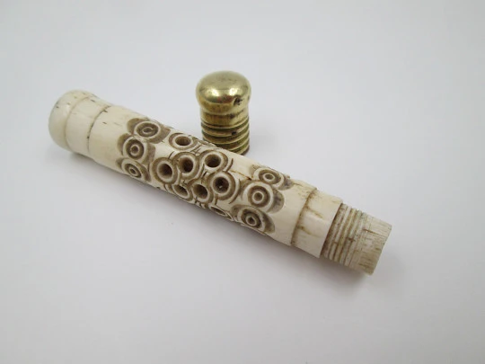 Pincushion. Carved openwork bone and golden metal. Circular pattern
