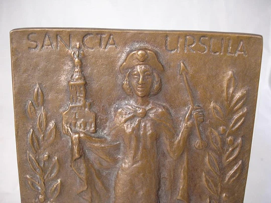 Placa bronce. Santa Úrsula. Argolla. Años 70. Alto relieve