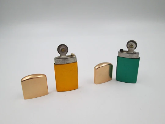 Pocket petrol lighter couple. Golden brass caps and colour lacquer bodies. Europe. 1960's