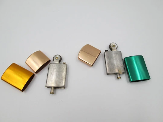 Pocket petrol lighter couple. Golden brass caps and colour lacquer bodies. Europe. 1960's