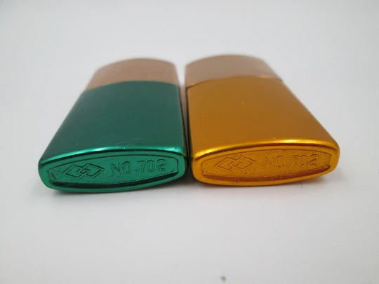 Pocket petrol lighter couple. Golden brass caps and colour lacquer bodies. Europe. 1960's