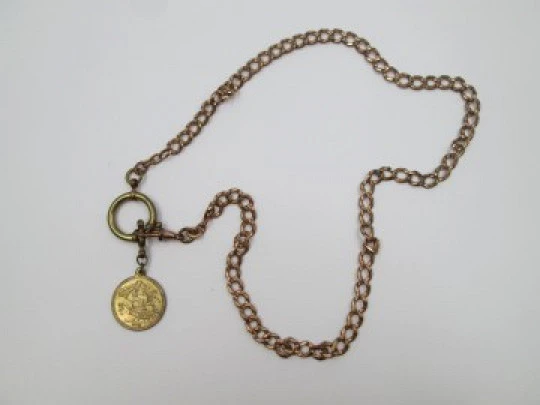 Pocket watch chain. Open braided links. Gold plated. Coin pendant. 1911