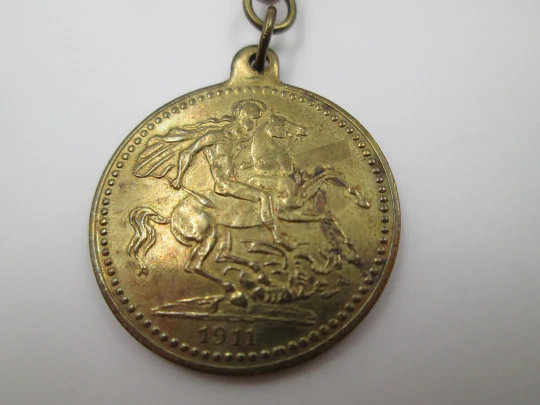 Pocket watch chain. Open braided links. Gold plated. Coin pendant. 1911
