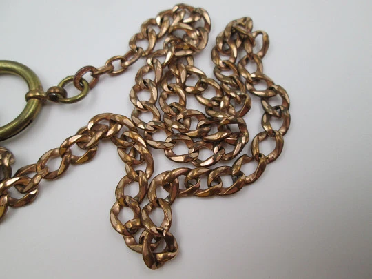 Pocket watch chain. Open braided links. Gold plated. Coin pendant. 1911