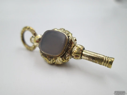 Pocket watch key fob. Gold plated. 19th century. Grey and black stones