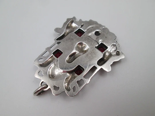 Portico pendant medal. Sterling silver and garnets. King with cherubs relief scene