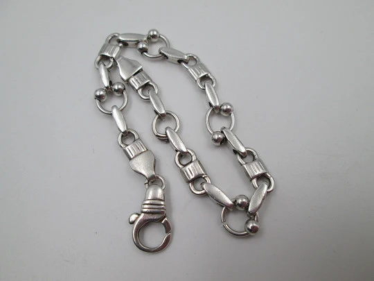Pulsera de eslabones para mujer en plata de ley. Motivos de aros y bolas. Cierre argolla