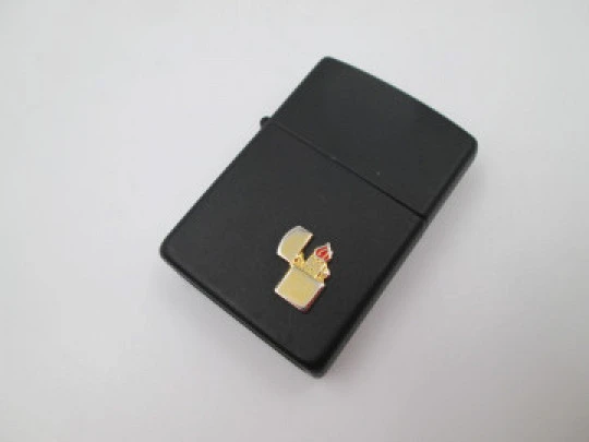 Rare Zippo petrol pocket lighter with relief motif. Black lacquer metal. USA. 1970's