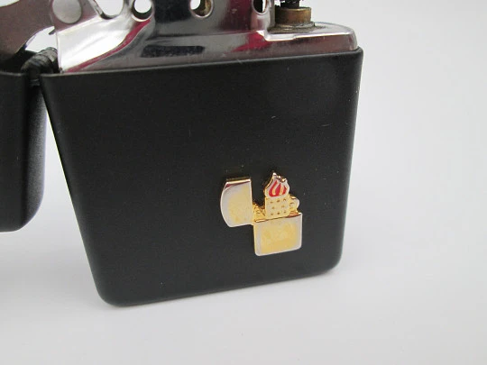 Rare Zippo petrol pocket lighter with relief motif. Black lacquer metal. USA. 1970's