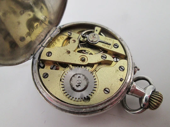 Reloj bolsillo plata ley. Esfera porcelana. Remontoir con pulsador. Motivos florales. 1890