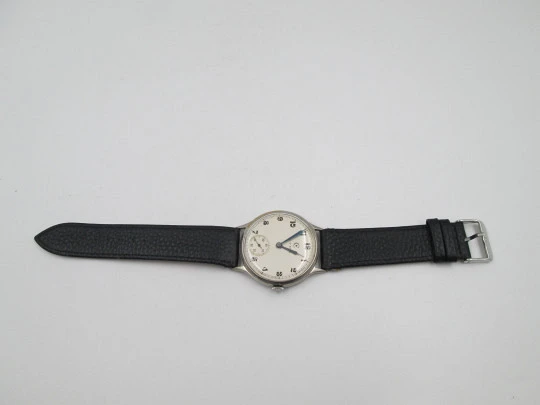 Reloj caballero Cyma Jumbo. Cuerda manual. Acero y metal plateado. Segundero. 1950