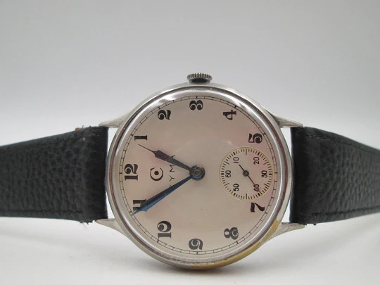 Reloj caballero Cyma Jumbo. Cuerda manual. Acero y metal plateado. Segundero. 1950