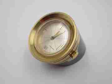 Reloj cilíndrico Jaguar. Bronce dorado y pavonado. Calendario. Cuerda. 1960