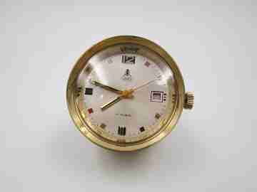 Reloj cilíndrico UWS. Bronce dorado. Calendario. 17 rubíes. Cuerda. 1970