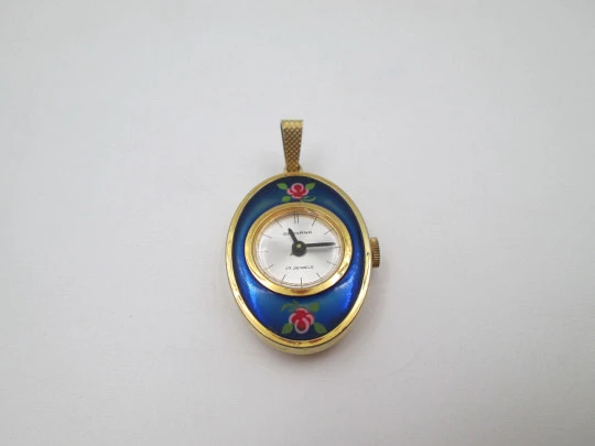 Reloj colgante Grovana. Metal dorado y esmalte de flores. Cuerda manual. Suiza. 1970