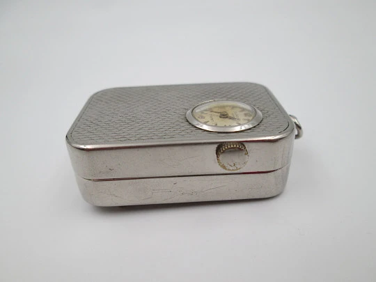 Reloj colgante R. Jaquet Genève con caja de música. Metal plateado. Cuerda manual. 1940