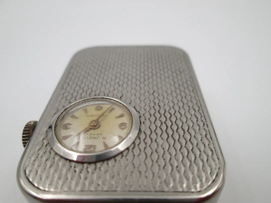 Reloj colgante R. Jaquet Genève con caja de música. Metal plateado. Cuerda manual. 1940