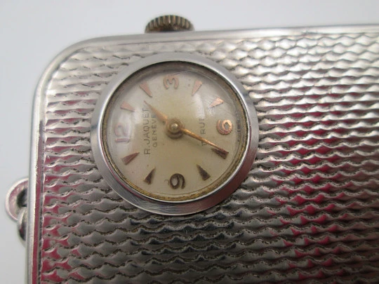 Reloj colgante R. Jaquet Genève con caja de música. Metal plateado. Cuerda manual. 1940