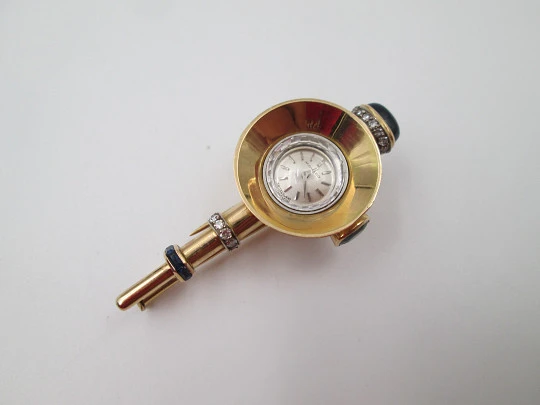 Reloj joya mecánico Movado. Oro 18k, diamantes, zafiros y esmeraldas. 1930