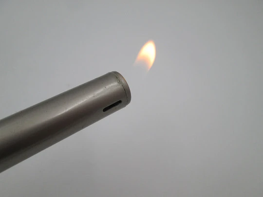 Rifle shape multi-purpose butane lighter. Silver and gold metal. Wood lacquer. 1990's