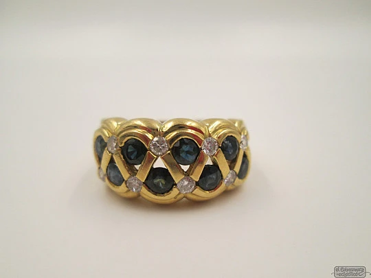 Ring. 18 karat yellow gold. Diamonds and sapphires. 1990's