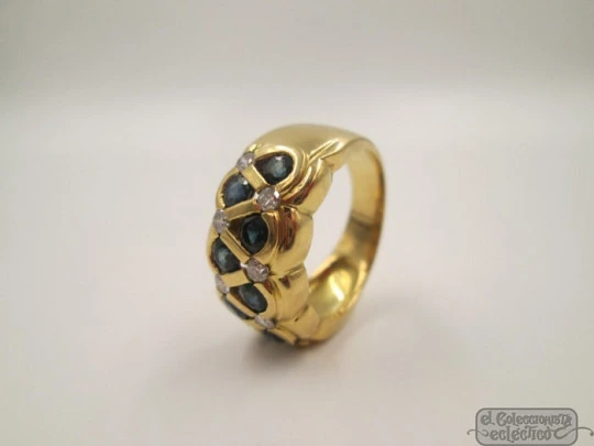 Ring. 18 karat yellow gold. Diamonds and sapphires. 1990's