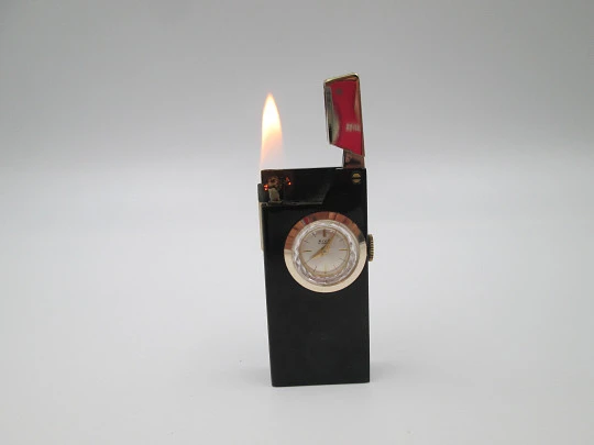 Rivo pocket petrol lighter / mechanical watch. Black lacquer metal & gold plated. 1960's