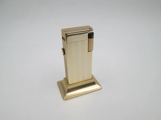 Rivo table petrol lighter / mechanical clock. Gold plated metal. 1960's. Swiss