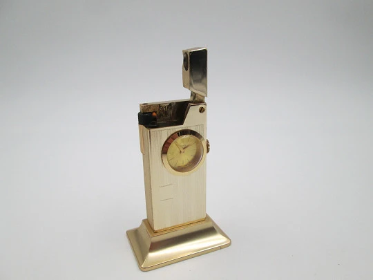 Rivo table petrol lighter / mechanical clock. Gold plated metal. 1960's. Swiss