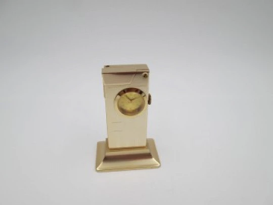 Rivo table petrol lighter / mechanical clock. Gold plated metal. 1960's. Swiss