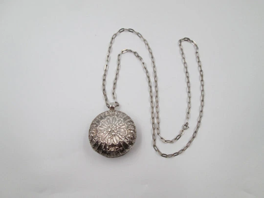 Round baby rattle with links chain. Sterling silver. Scrolls and floral motifs. Spain. 1960's
