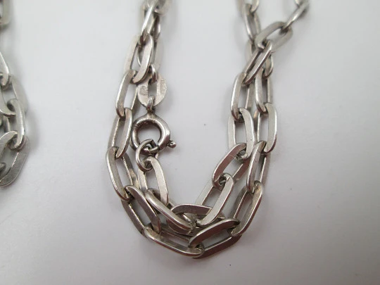 Round baby rattle with links chain. Sterling silver. Scrolls and floral motifs. Spain. 1960's