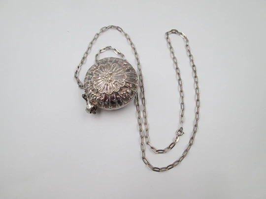 Round baby rattle with links chain. Sterling silver. Scrolls and floral motifs. Spain. 1960's
