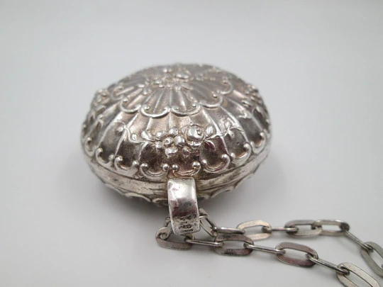 Round baby rattle with links chain. Sterling silver. Scrolls and floral motifs. Spain. 1960's