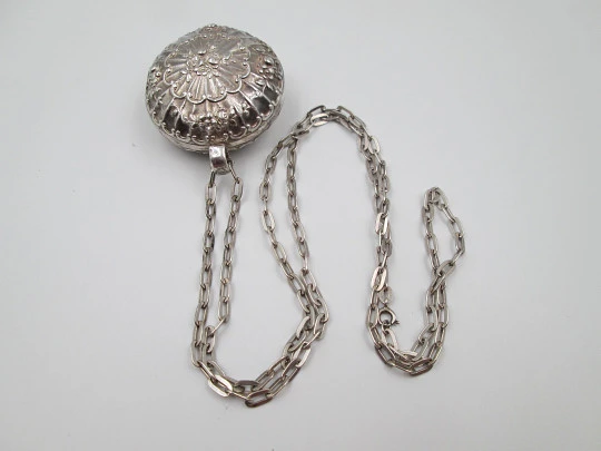 Round baby rattle with links chain. Sterling silver. Scrolls and floral motifs. Spain. 1960's