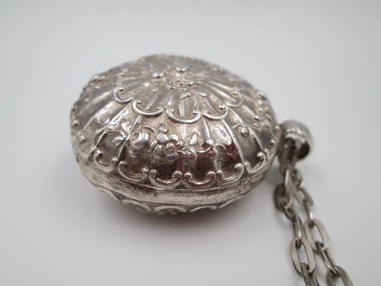 Round baby rattle with links chain. Sterling silver. Scrolls and floral motifs. Spain. 1960's
