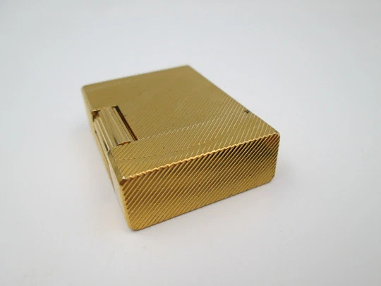 S.T. Dupont lighter. Gold plated metal. Lines pattern & anagram. 2001