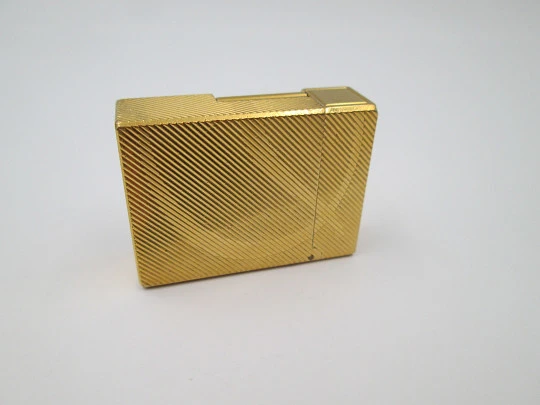 S.T. Dupont lighter. Gold plated metal. Lines pattern & anagram. 2001