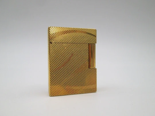 S.T. Dupont lighter. Gold plated metal. Lines pattern & anagram. 2001