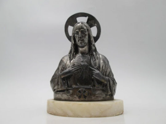 Sacred Heart of Jesus sculpture. Pewter and white marble oval stand. Spain. 1940's