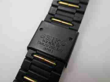 Seiko. Black and gold metal. Steel back. Quartz. Square case. Bracelet. 1980's. Japan