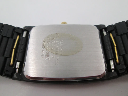 Seiko. Black and gold metal. Steel back. Quartz. Square case. Bracelet. 1980's. Japan