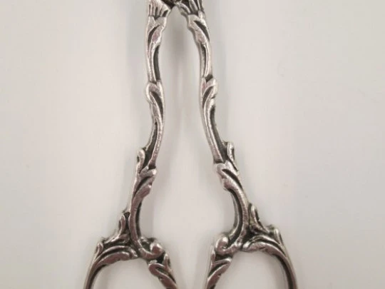 Serving tongs. Sterling silver. Openwork design. Relief scenes