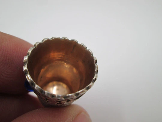 Sewing thimble. Sterling silver and vermeil inside. Edge with blue stones. 1950's