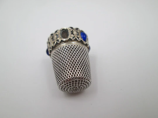 Sewing thimble. Sterling silver and vermeil inside. Edge with blue stones. 1950's