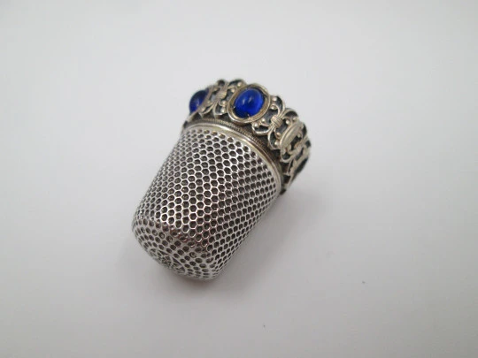 Sewing thimble. Sterling silver and vermeil inside. Edge with blue stones. 1950's