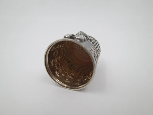 Sewing thimble. Sterling silver. Bear relief figure and vegetable motifs. Europe. 1960's