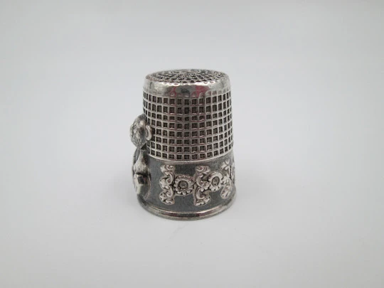 Sewing thimble. Sterling silver. Bear relief figure and vegetable motifs. Europe. 1960's